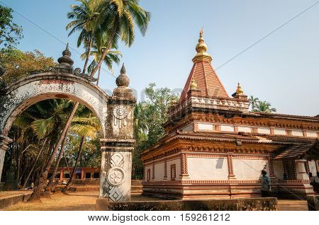 Morjim Goa India - December 08 2014: Ancient Hindu Shree Morjai Temple at Morjim amidst a coconut grove. In the temple celebrate Kalas Utsav. The walls are adorned with the rare and extinct Kaavi art friezes