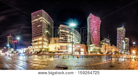 Night skyline of Warsaw with soviet era Palace of Culture and science and modern skyscrapers. Panoramic montage from 10 images