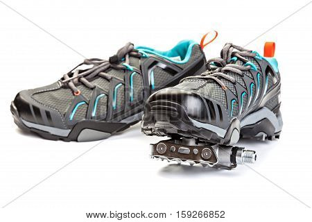 Pair of cycling boots with pedal attached to the sole isolated on white background.