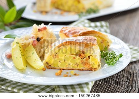 Hearty Austrian cuisine: Potato strudel with greaves, served with bacon sauerkraut