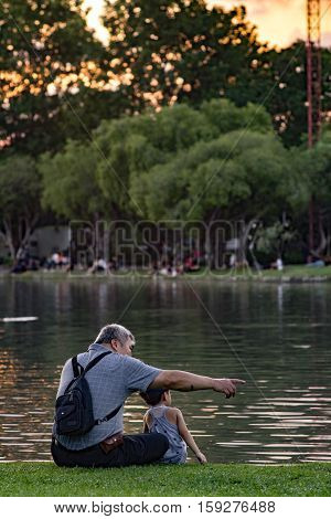 Grandpa And Nephew Relaxing In Chatuchak Park