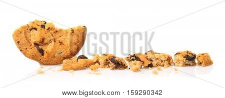 Tasty cookie with chocolate chips and crumbs on white background