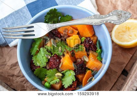 Vegan garnish. Boiled sweet potatoes with green peas cilantro and linseed oil. Perfect for the detox diet or just a healthy meal. Love for a healthy raw food concept.