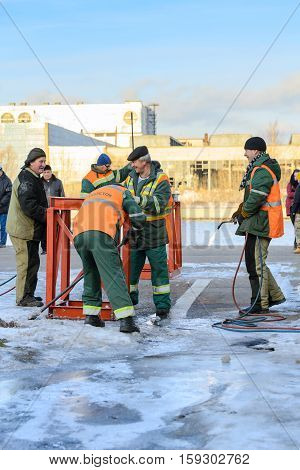 MOSCOW, RUSSIA - NOVEMBER 11, 2016: State Unitary Enterprise Mosvodostok performs recovery vessels on coastal winter parking. Dockers prepare the place for the installation vessel.