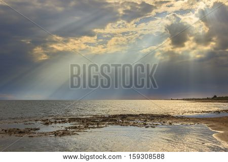 Salento coast: horizon sea with cloudy sunset. Apulia,ITALY. Typical beach with sandy coves and cliffs from Torre Pali to Pescoluse. Shoreline dominated by cloudscape.
