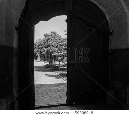 a view of the city through the ancient doors are open