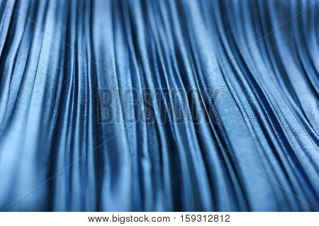 Blue textured crinkled fabric closeup. Selective focus.