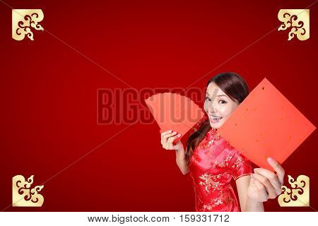 Smile Chinese woman dress traditional cheongsam and introduce on red background. asian beauty
