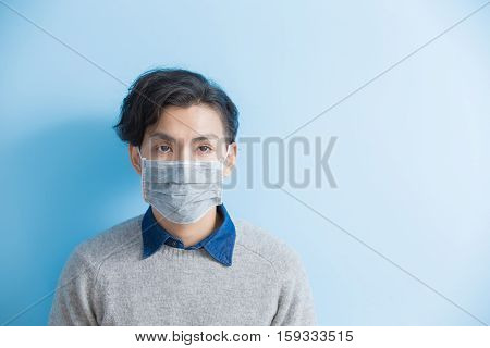 man feel sick with isolated blue background asian