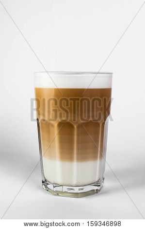 coffee in a tall glass with cream poured over