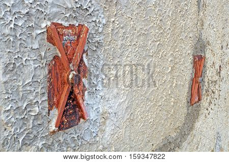 Facade of an old italian masonry building with metal tie-rod and anchor plate
