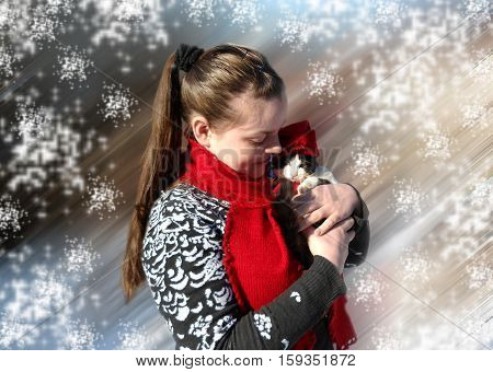 The girl in the red scarf. Girl and kitten. Winter day. Red hat and red scarf