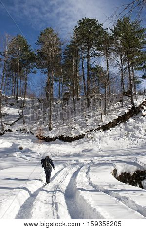 climber man is walking on the snowy mountain