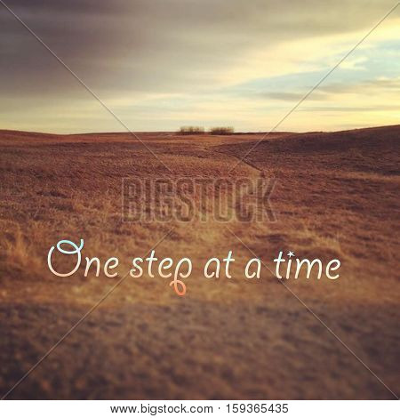 Inspirational quote on scenic field landscape with bright sky, orange grass and isolated bushes at sunset.  Peaceful prairie sunset field landscape view. Bright sky. Lighting and blurred effects.