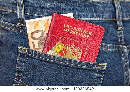MOSCOW RUSSIA - NOVEMBER 27 2016: Russian passport banknote 50 euro and credit card MasterCard in back jeans pocket. Travel concept