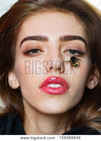 Pretty girl cute sexy young beautiful woman brunette female model with sexi pink lips and humblebee bee on face