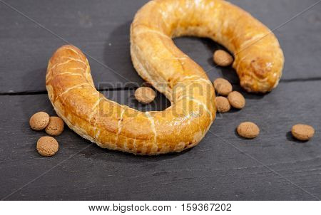 Traditional Dutch cookie Banketletter at Sinterklaas celebration on wooden background