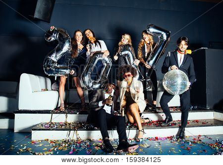 Multi-ethnic group of friends celebrating the end of the year in a nightclub - Sylvester party clubbers having party on new year's eve