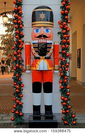Soldier nutcracker statue and Christmas tree decoration on the street