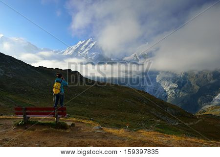 The woman hiker are looking from Rotenboden station to mountain view in summer Zermatt Switzerland