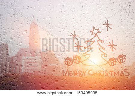 draw christmas tree and word on raining window morning light
