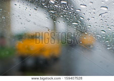 Rainy street of Kolkata West Bengal India. Blurred view of famous yellow taxis of Kolkata moving on street with flyover in background monsoon Indian stock image.