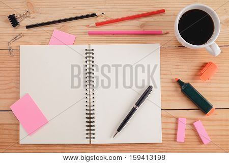 Office desk table with notebook color pencil cup of coffee and note paper . Top view with copy space (selective focus)