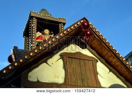 Mom and papa christmas on a wooden tower on a cottage