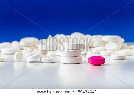 Bunch Of White Tablets. Scattered Pills. Single Pink Pill