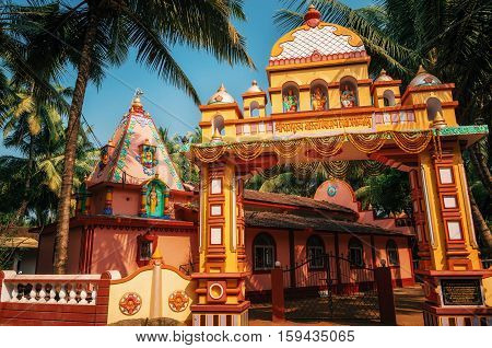 Vivid colorful Hindu Temple at Morjim amidst a coconut grove North Goa India.