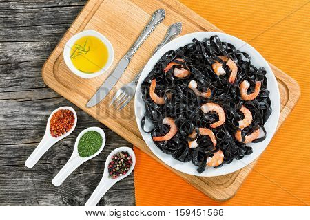 Black Noodles With King Prawns On White Dish