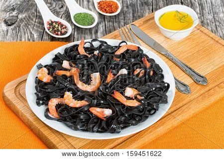 Black Noodles With King Prawns On White Dish