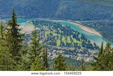 An elevated of view of a golf course Revelstoke townsite and Columbia River. Revelstoke British Columbia Canada