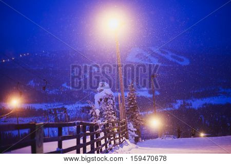 Beautiful cold mountain view of ski resort, winter day with slope, piste and ski lift, evening twilight night picture