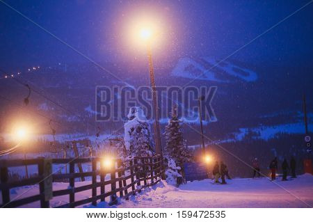 Beautiful cold mountain view of ski resort, winter day with slope, piste and ski lift, evening twilight night picture