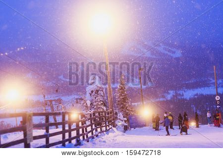 Beautiful cold mountain view of ski resort, winter day with slope, piste and ski lift, evening twilight night picture