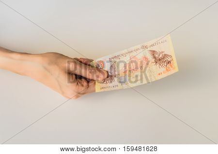 Woman Holding Five Bhutanese Ngultrum Banknote In Her Hand