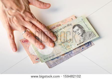Woman Hand On Bhutanese Ngultrum Banknotes Currencies