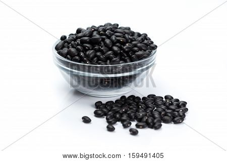 container of black beans grain on white background