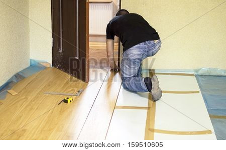 The Process Of Installing Laminate Wooden On The Floor