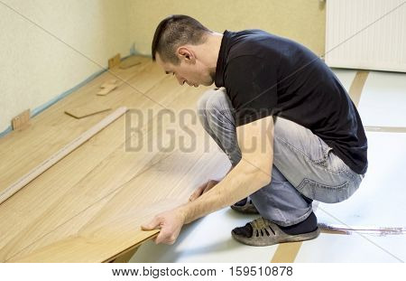 The Process Of Installing Laminate Wooden On The Floor