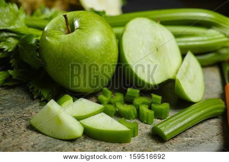 Green vegetables and fruits - celery shoots and apples healthy fitness diet concept