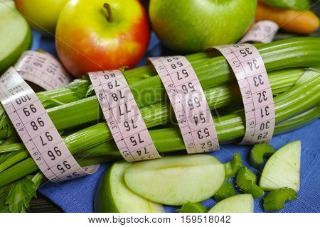 Green vegetables and fruits - celery shoots and apples healthy fitness diet concept