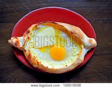 Plate with adzharian khachapuri the traditional georgian meal