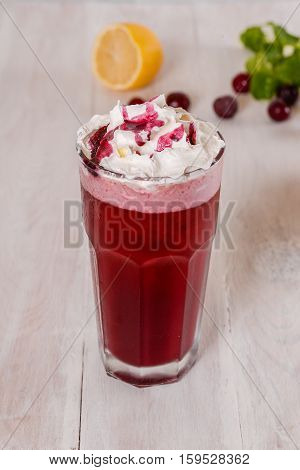 Milkshake shot close-up on a wooden background in the decoration