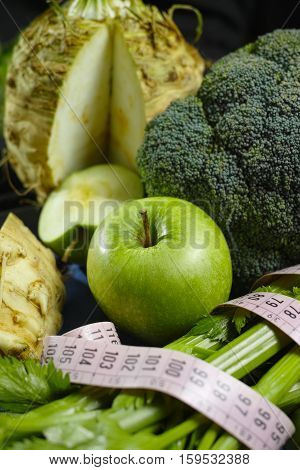 Green vegetables and fruits - celeriac broccoli celery shoots and apples healthy fitness diet concept