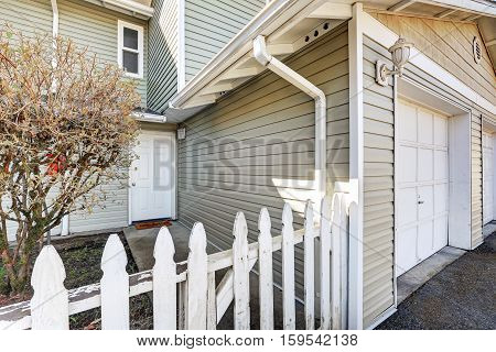 Entrance Of Duplex Home With Picket Fence