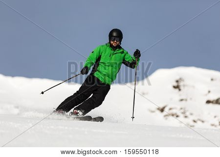 Male Skier Skiing On Ski Slope
