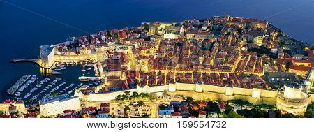 Panoramic aerial view of Dubrovnik old town and harbor at night