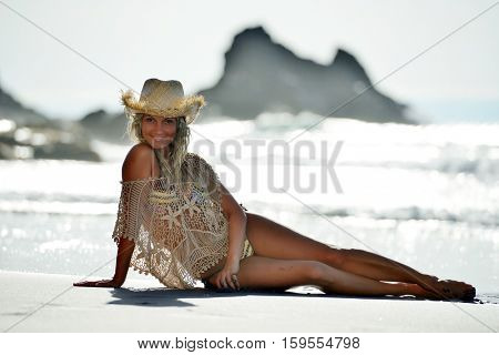 young woman relaxing on the beach in summer day